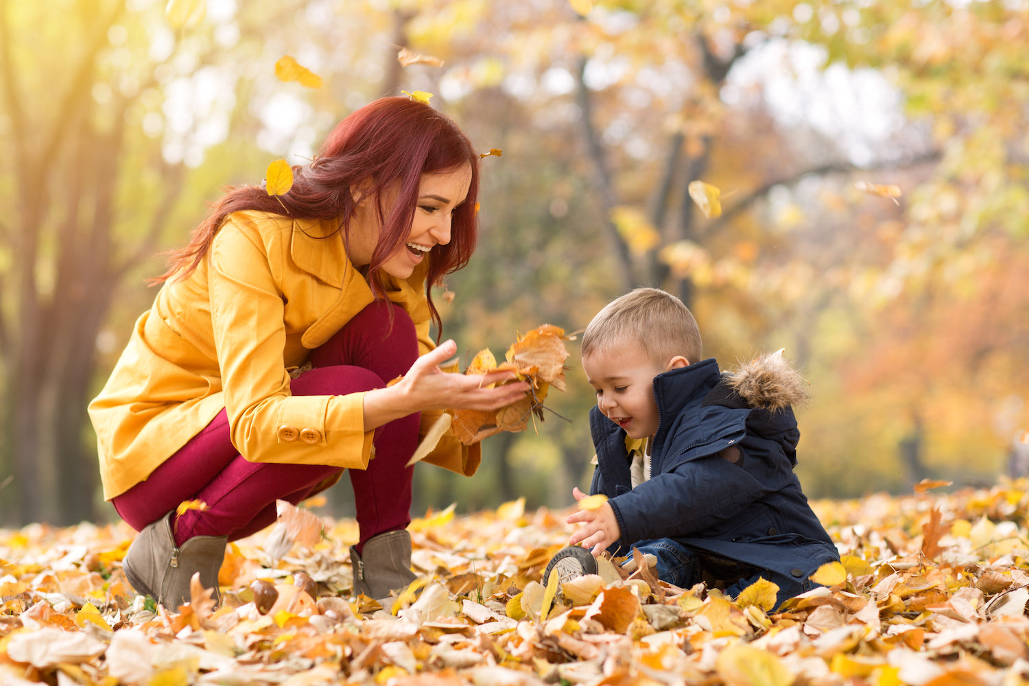 Mother and son playing in leaves