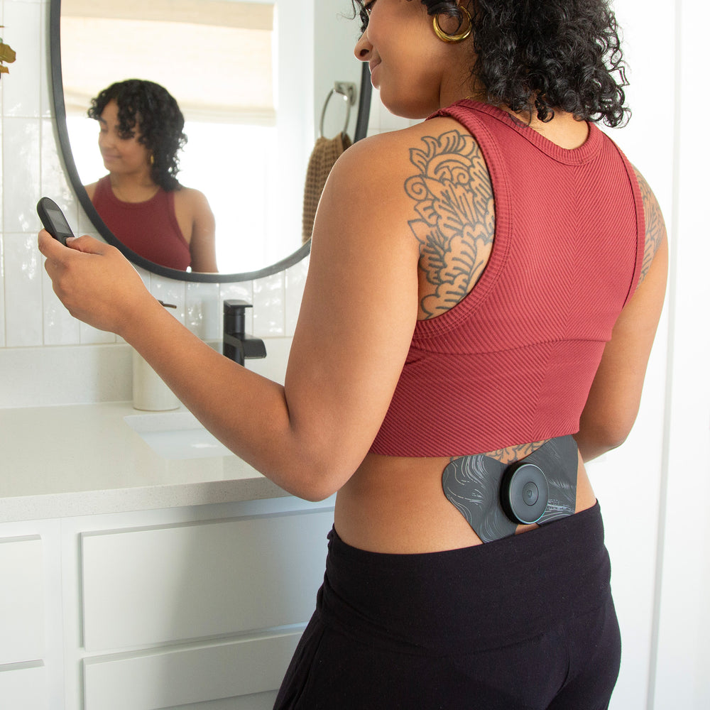 Woman using the Chirp Halo on her lower back