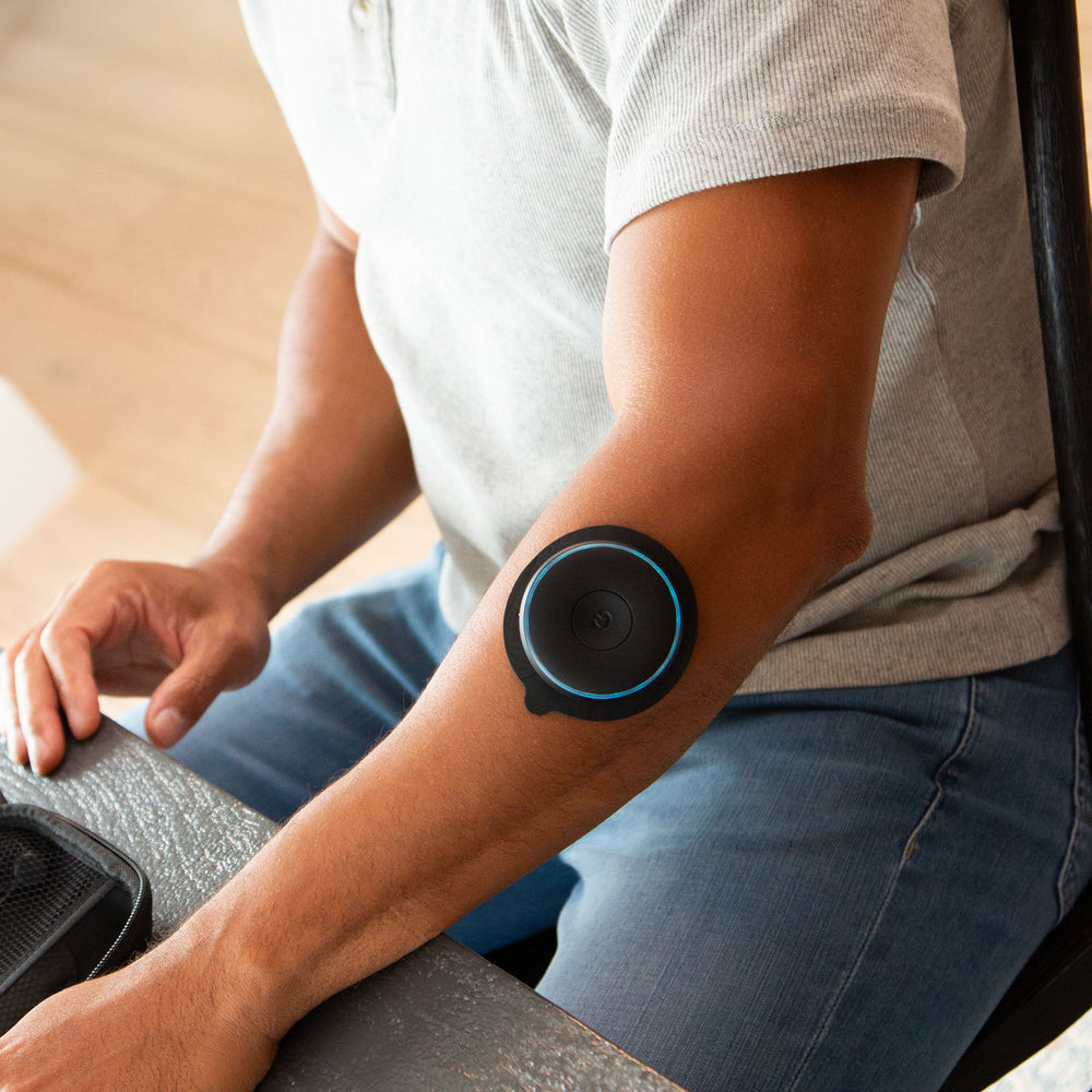 Man sitting with Chirp Halo using trigger pad on forearm