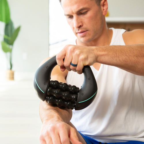 Man massaging his forearm with Chirp RPM mini