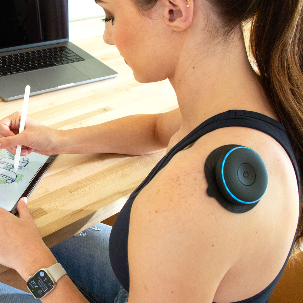 Woman sitting with Chirp Halo using trigger pad on shoulder